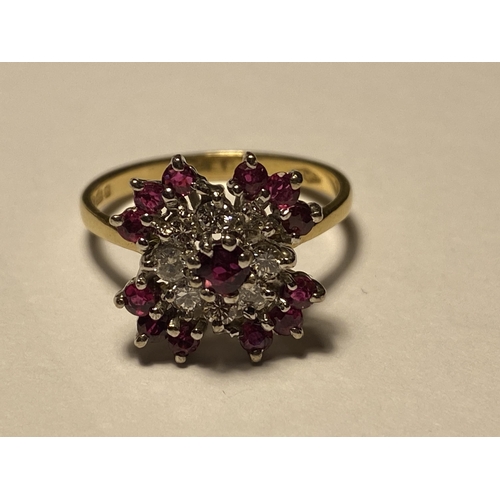 218 - An 18ct yellow gold ruby and diamond cluster ring, approx size O, stamped 750