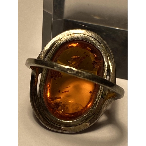 241 - A silver set amber cabochon ring, stamped 925, approx size L