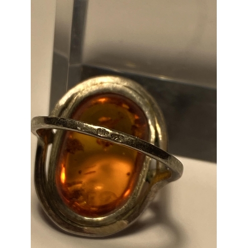 241 - A silver set amber cabochon ring, stamped 925, approx size L