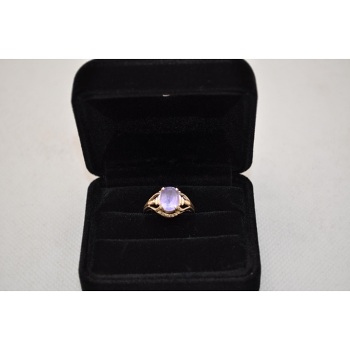 184 - A 10K yellow gold ring has central oval amethyst stone in delicate design raised mount, approx. size... 