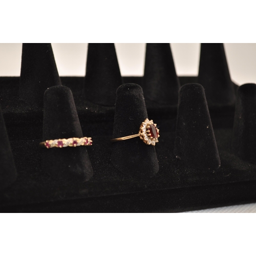 186 - X2 RINGS -  9ct yellow gold rings with one with ruby and diamond and the other with a central garnet... 