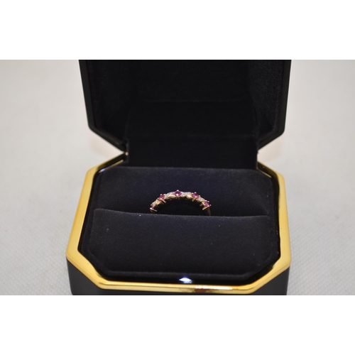 186 - X2 RINGS -  9ct yellow gold rings with one with ruby and diamond and the other with a central garnet... 