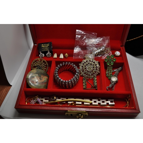 128 - Two boxes of costume jewellery to include an iridescent dragonfly brooch, rings, two sets of screw b... 