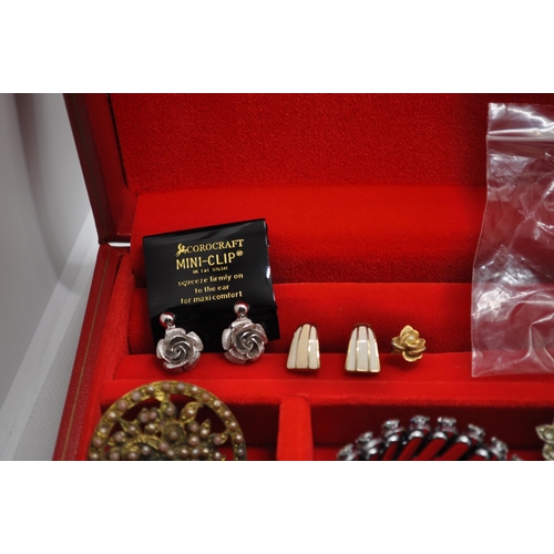 128 - Two boxes of costume jewellery to include an iridescent dragonfly brooch, rings, two sets of screw b... 