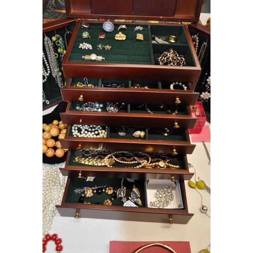 137 - A  large jewellery box full of costume jewellery to include rings, necklaces, brooches, and beads, s... 