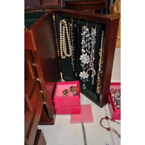 137 - A  large jewellery box full of costume jewellery to include rings, necklaces, brooches, and beads, s... 