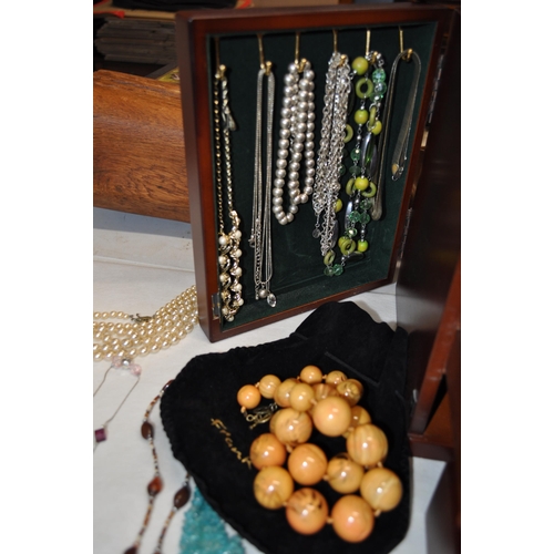 137 - A  large jewellery box full of costume jewellery to include rings, necklaces, brooches, and beads, s... 