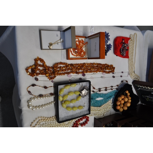 137 - A  large jewellery box full of costume jewellery to include rings, necklaces, brooches, and beads, s... 