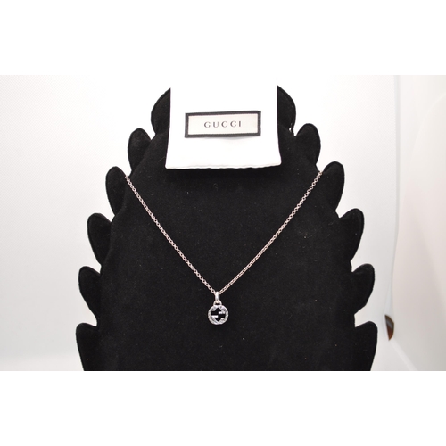 167 - A Gucci silver necklace hallmarked 925 pendant with an extendable 20 inch chain with pouch, booklet,... 