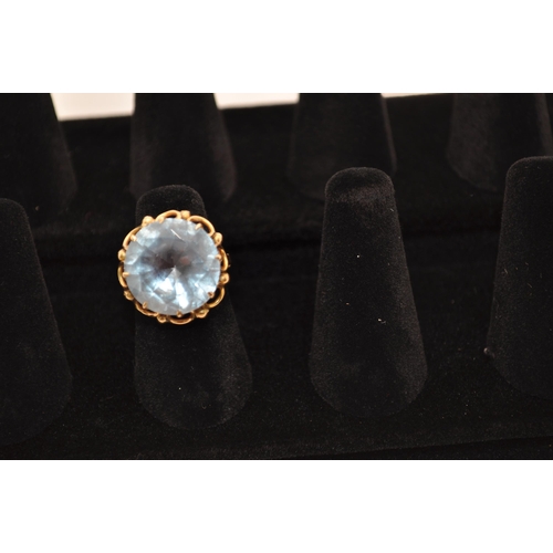 177 - A 18ct yellow gold ladies cocktail ring with central aquamarine stone (approx. diameter 1.75cm) set ... 