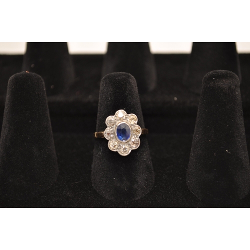 180 - Antique yellow gold cluster ring. with eight rose cut diamonds surrounding central oval sapphire sto... 