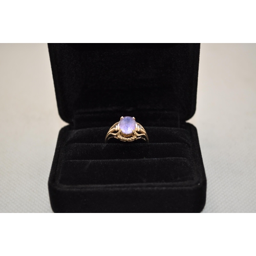 184 - A 10K yellow gold ring has central oval amethyst stone in delicate design raised mount, approx. size... 