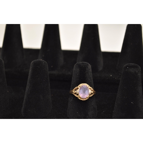 184 - A 10K yellow gold ring has central oval amethyst stone in delicate design raised mount, approx. size... 