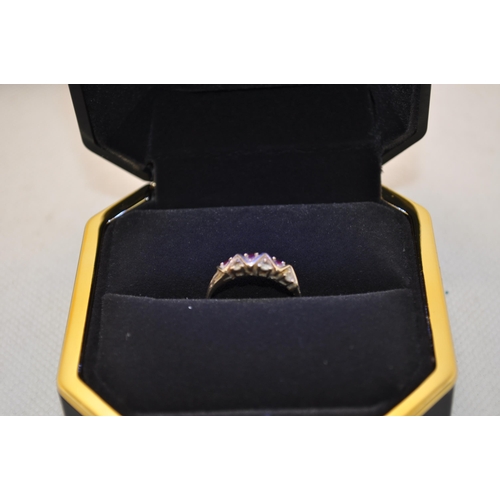 185 - Yellow gold ring stamped 585 with zig zag alternate diamond and ruby design Size O, approx. 1.75g