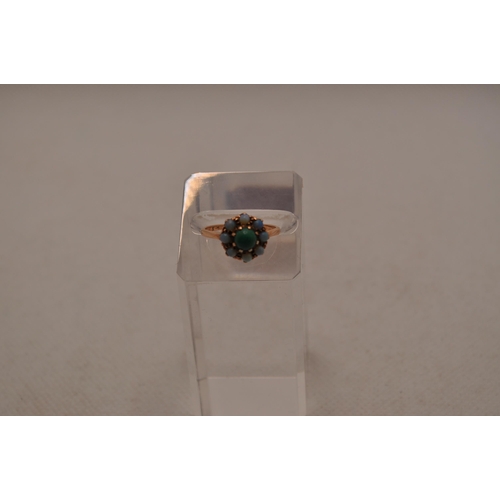 187 - 9ct gold ring with inset likely green turquoise stone with surrounding opals, approx size L