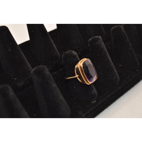 192 - Yellow gold ring with rectangular design featuring a faceted amethyst Hallmarked 9ct. Central stone ... 