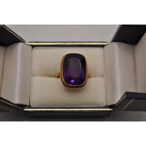 192 - Yellow gold ring with rectangular design featuring a faceted amethyst Hallmarked 9ct. Central stone ... 