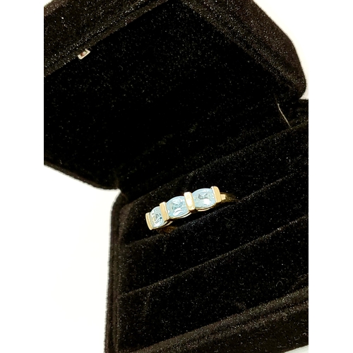 210 - 9ct yellow gold ladies ring with 3 blue topaz stones, size P