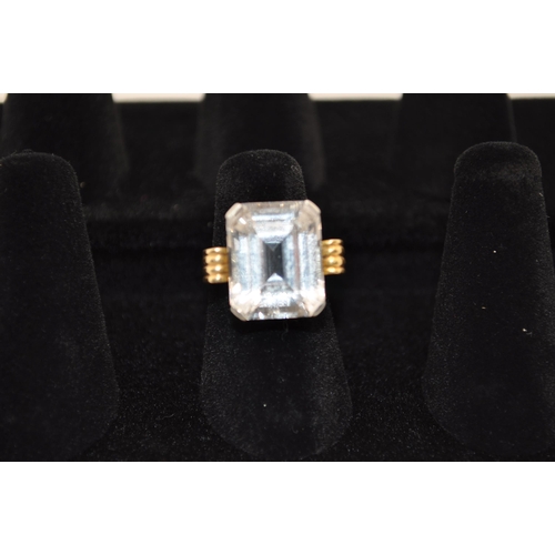 238 - A 18ct yellow gold and platinum spectacular cocktail ring with rectangular faceted white sapphire st... 