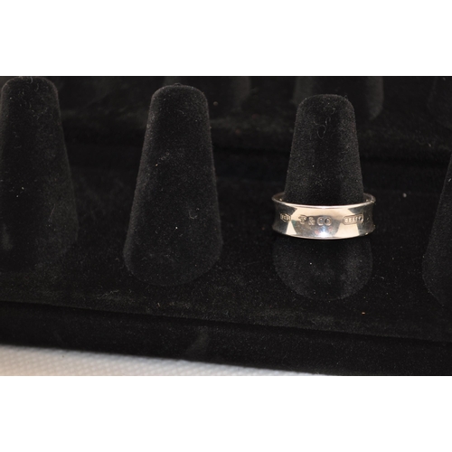 240 - Tiffany & Co solid silver ring with a concave design hallmarked Tiffany & Co on inner and outer of b... 