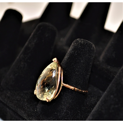 243 - Green topaz ring faceted teardrop shape stone with decorative band approx. size N, stamped 375