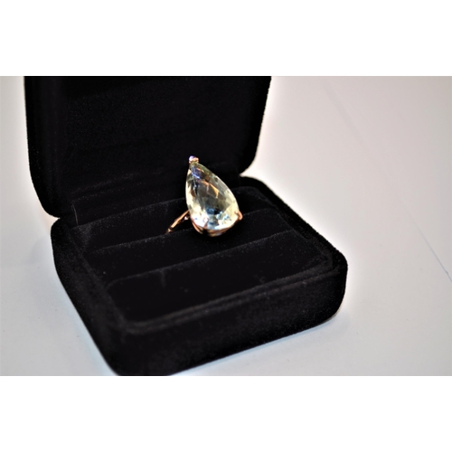 243 - Green topaz ring faceted teardrop shape stone with decorative band approx. size N, stamped 375