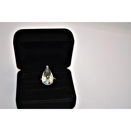 243 - Green topaz ring faceted teardrop shape stone with decorative band approx. size N, stamped 375