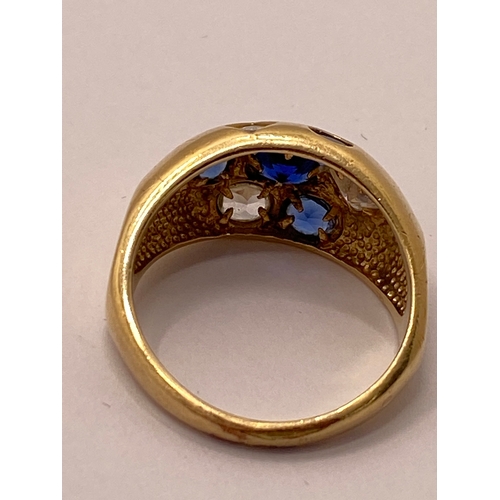 24 - A yellow gold ring, marked 09 with blue and clear stones approx. size R, approx. weight 4.7g