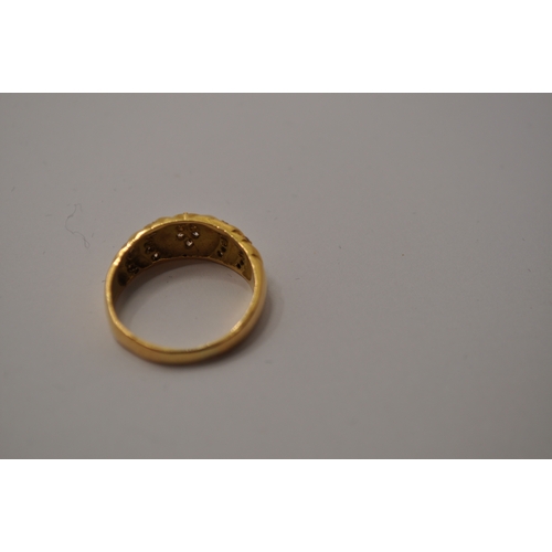 178 - A ring stamped 18k with bands of clear stones inset into the design approx. size 0/P, approx. gross ... 