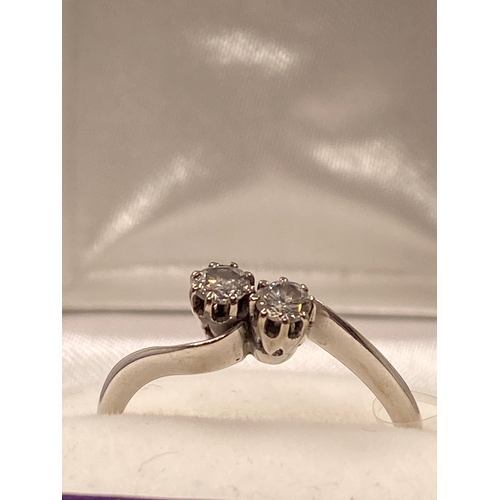 9 - 18ct white gold diamond ring in an interlocking twin stone design, approx 0.30cts, size O/P