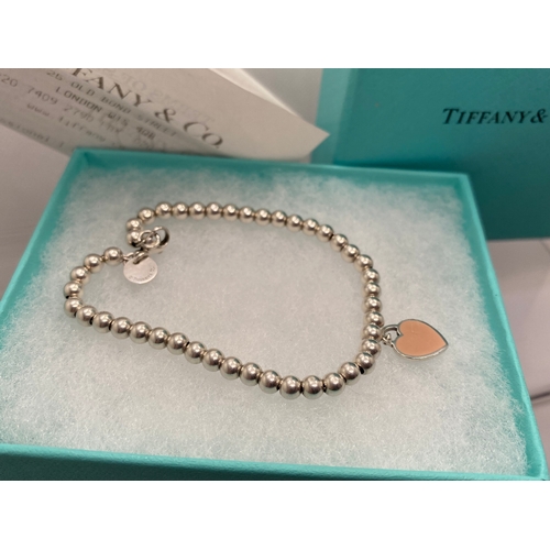 102 - Tiffany & Co silver beaded bracelet with a heart charm hallmarked Tiffany &co 925 silver, with box a... 