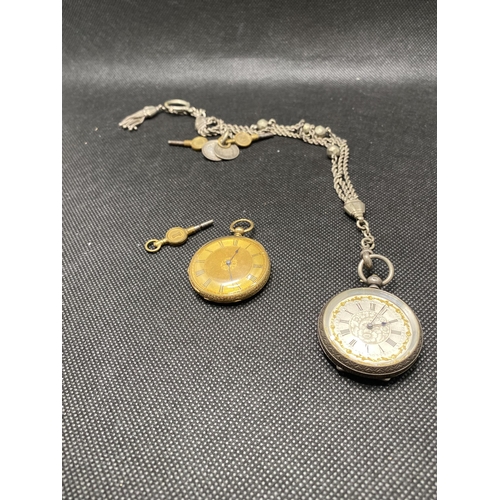 Antique 18ct gold cased pocket watch, stamped 18K to inside of case approx. gross weight 32g (ticking at time of cataloging)  together with a ladies silver pocket watch on a chatelaine with two Victorian coins and watch keys, stamped 0.935