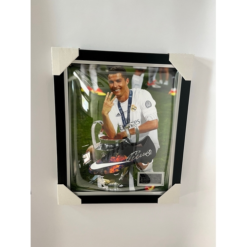 A signed Cristiano Ronaldo champions league winner 2016 Nike cr7football boot in a dome frame with photo of him to background approx. W 52cm X L 63cm.  Provenance: consigned into auction from ex-professional footballer