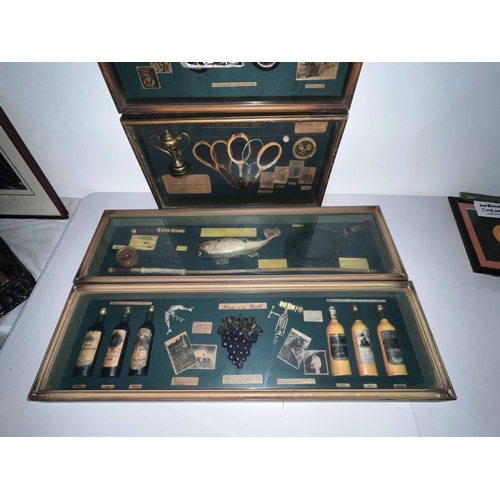 125 - A selection of four boxed display cabinets with items such as wines, fishing, golf, motorcycling etc... 