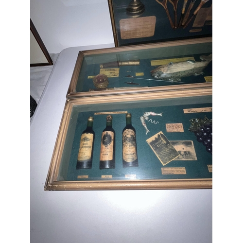 125 - A selection of four boxed display cabinets with items such as wines, fishing, golf, motorcycling etc... 