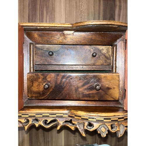 133 - A handcrafted wooden miniature oval chest of drawers with a metal base