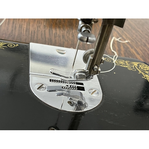 15 - Singer sewing machine serial no Y9496305, model no.66 with BRK electric motor on Singer table (model... 