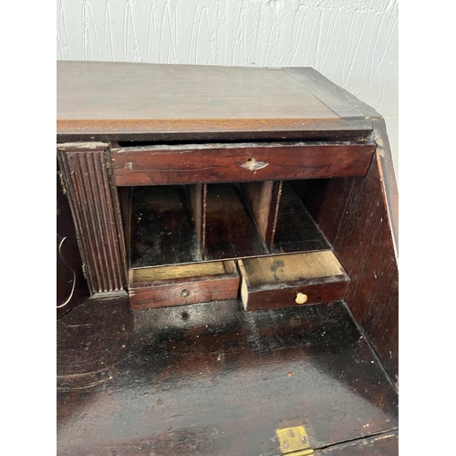 43 - Antique oak bureau, the fall front opening to reveal an interior arrangement of drawers and pull-dow... 