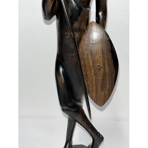 64 - Ebonised wooden figure of an African warrior together with x3 prints from different artists depictin... 