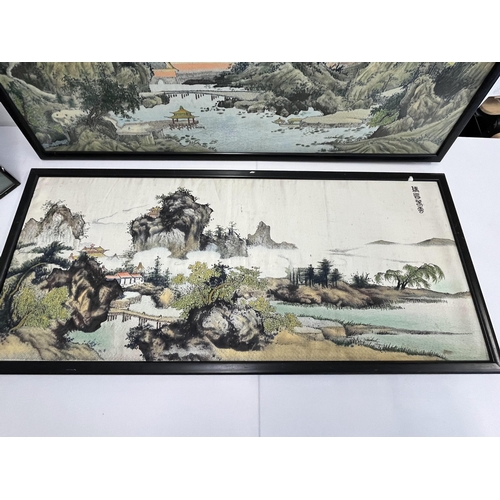 69 - A pair of oriental framed silks depicting landscape scenes alongside a framed 3D silk of a lady