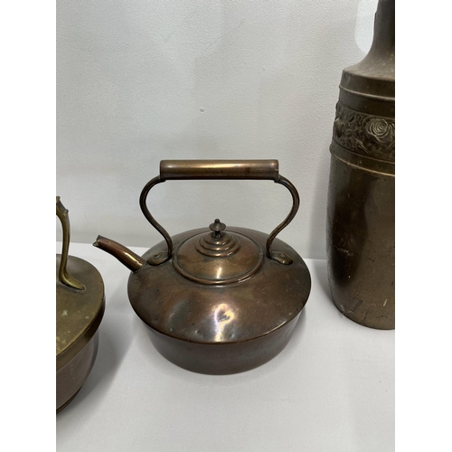 71 - An assortment of brass and copperware items to include chargers, kettles, buckets, jam pan etc.