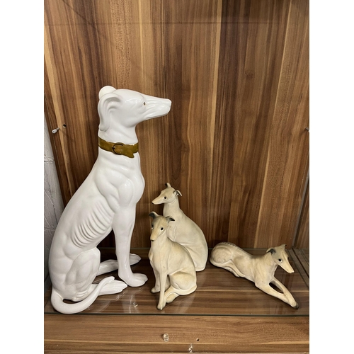 79 - A group of three Charisma greyhound dogs in varying heights  together with a larger glazed ceramic g... 