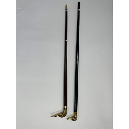 92 - Two walking sticks both featuring brass duck head designs to handle, approx. length of ebonised stic... 