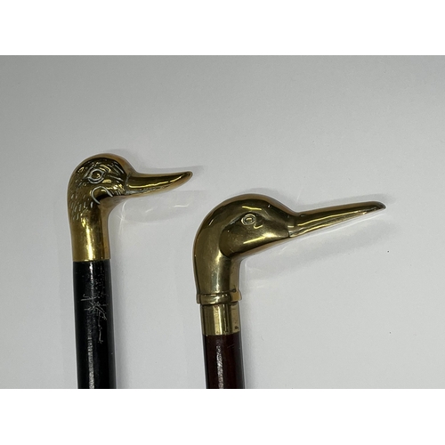 92 - Two walking sticks both featuring brass duck head designs to handle, approx. length of ebonised stic... 