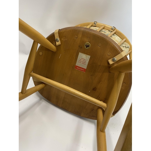 110 - Child's Ercol rocker chair with tapestry design to seat, gold Ercol label to underside