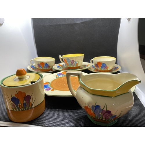 166 - A mixture of Clarice Cliff 'Crocus' cups, saucers, sugar pot and milk jug together with autumnal hon... 