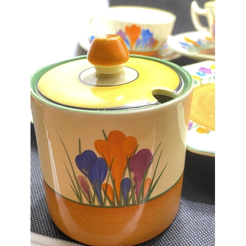 166 - A mixture of Clarice Cliff 'Crocus' cups, saucers, sugar pot and milk jug together with autumnal hon... 