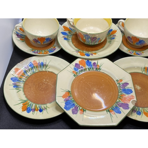 166 - A mixture of Clarice Cliff 'Crocus' cups, saucers, sugar pot and milk jug together with autumnal hon... 