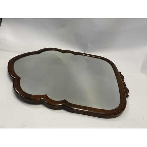 24 - A vintage mirror in a shield style design wooden trim, approx. L 68cm X W 55cm