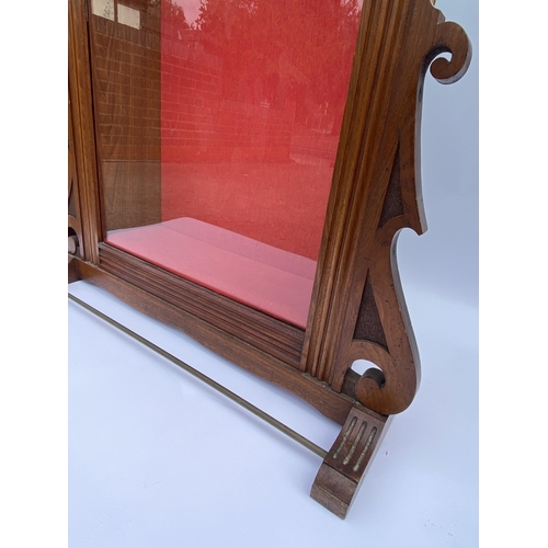 35 - Bespoke freestanding display cabinet with scroll detailing to top and upholstered with red interior,... 